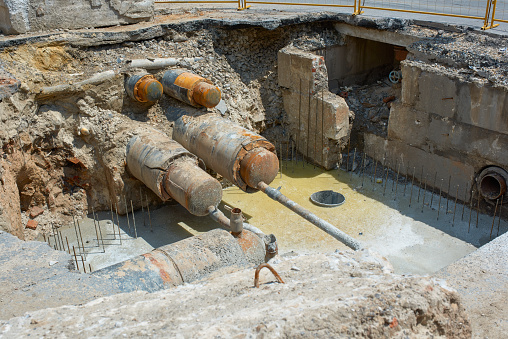 View of underground water pipes. Repair of the heating main underground. Underground water collector.