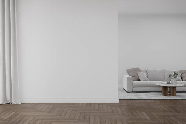 istock Empty white wall with sofa and carpet on wooden floor. 1446072313