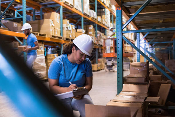 istock Female manager uses checklist to document warehouse inventory 1446073029