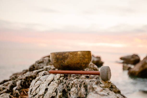 istock Golden singing bowl stands on a stone - closeup 1446074268