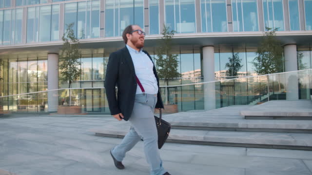 Overweight businessman dance commuting to work. Realtime
