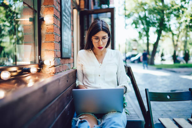 istock Hispanic millennial reading received email message during time for online browsing and networking social websites, attractive hipster girl with laptop device watching video vlog during leisure 1446075564