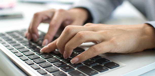 istock Close up of female hands typing on laptop keyboard. 1446077021