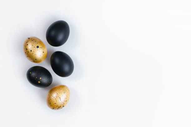 istock Eggs painted gold and black on white background. Minimal Easter concept. Golden luxury backdrop 1446077465