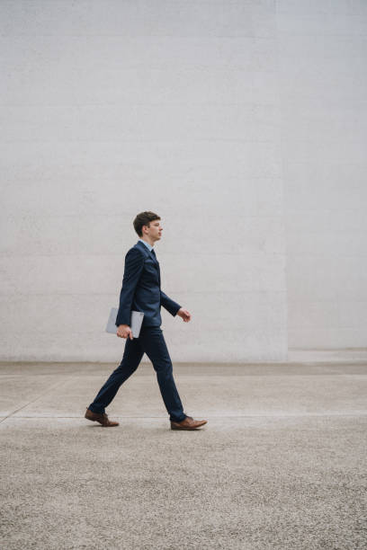 istock Young male businessman walking with a tablet 1446078886