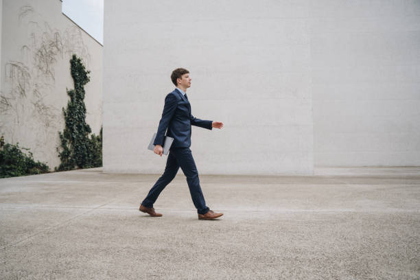 istock Young male businessman walking with a tablet 1446078907