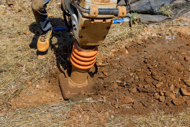 quando si utilizza lo strumento compattatore della pressatrice, le piastre vibranti saltano quando si compattano a terra durante la costruzione - jumping jack compactor foto e immagini stock