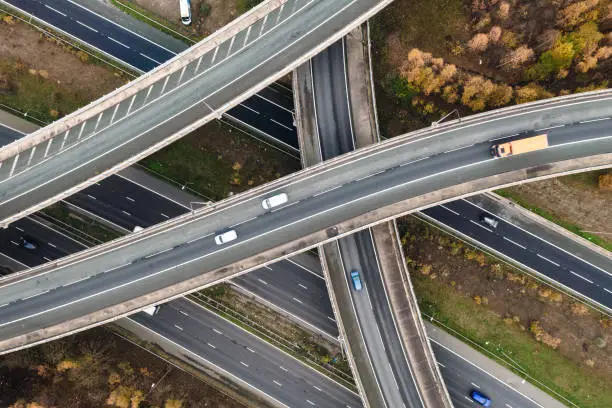 An aerial view above a complex motorway junction with slip roads and overbridges connecting the M62 and A1 motorways in the UK