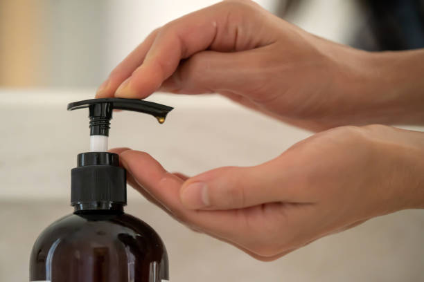 Girl washes her hands with soap.