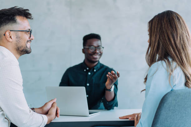 istock Group of business persons talking in the office. 1446082963