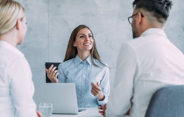 istock Group of business persons talking in the office. 1446082967