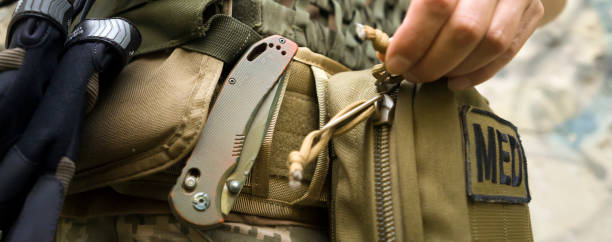 istock A soldier, a tactical medic opens a first aid kit, close-up view. 1446083436