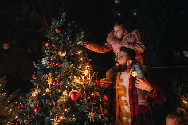 istock Loving father and his daughter by a Christmas tree 1446084265