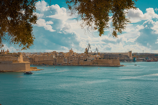 View from Mausoleum in the Barakka gardens in Valletta, Malta on a beautiful summer day. Picturesque antique houses and fortress across the bay.