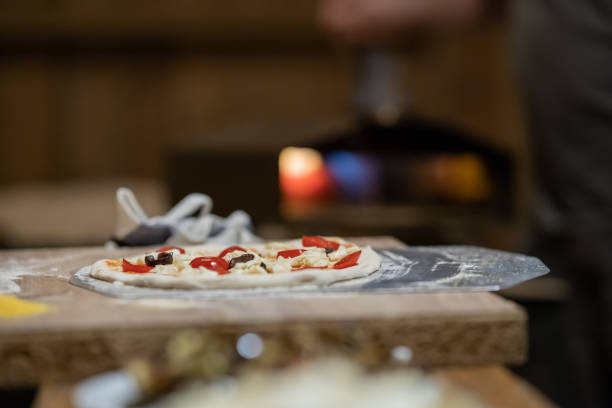 istock Fresh home made pizza waiting to be inserted in an oven in the b 1446084729