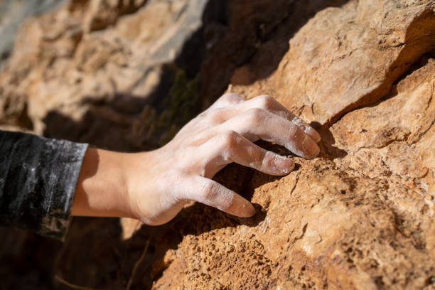 istock Hand with magnesia on the rock closeup, rock climbing. 1446084781