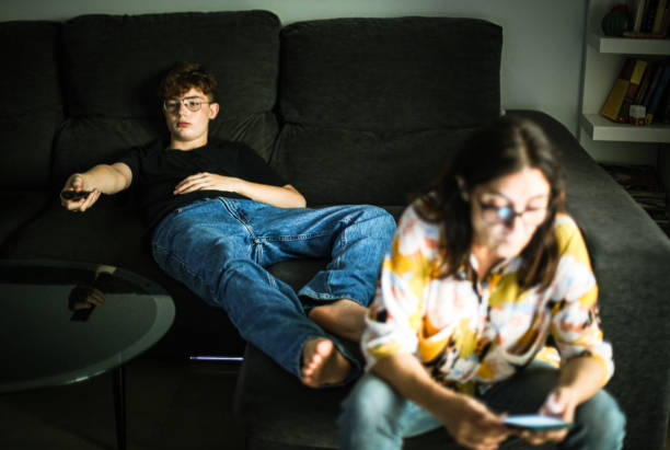 istock mother and son relaxing on the sofa watching tv and using smart phone 1446084890