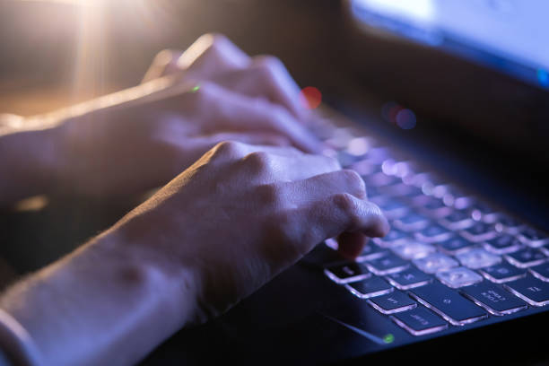 istock Girl is working on a laptop at night, hands closeup. 1446085975