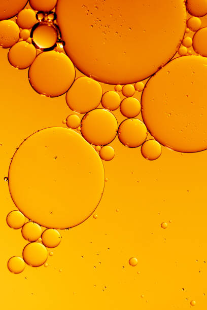 istock Golden yellow abstract oil bubbles or face serum background. 1446086135