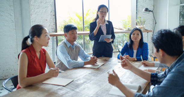 istock Asian Businesswoman Leading Training Session in Modern Office 1446092970