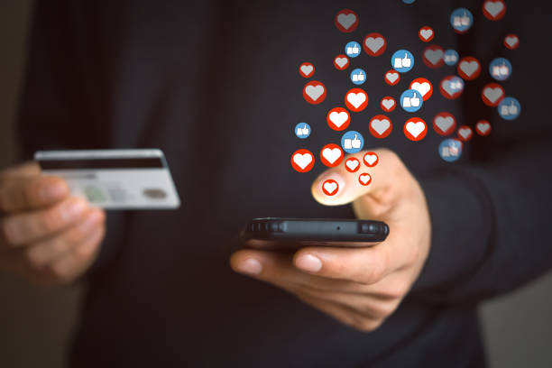 istock Man holds a phone and send likes, hearts as a feedback. 1446093224