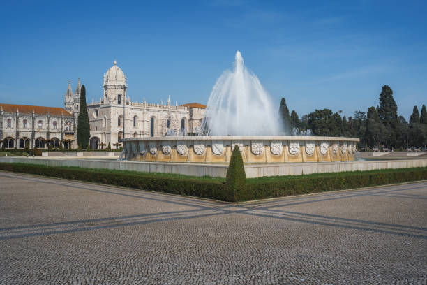 Fountain at Jardim da Praca do Imperio Square with Jeronimos Monastery - Lisbon, Portugal