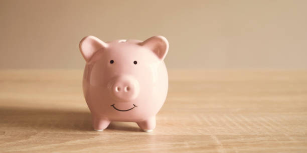 istock Cute piggy bank on the table. 1446094104