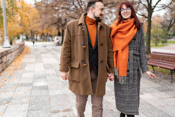 istock Happy couple in love walking in park 1446094512