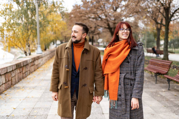istock Happy couple in love walking in park 1446094537