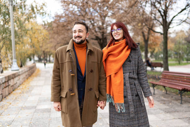 istock Happy couple in love walking in park 1446094538