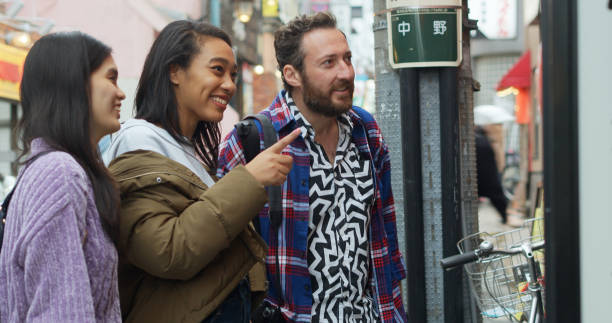 istock Tourists in Japan Looking Through Shop Window 1446095626
