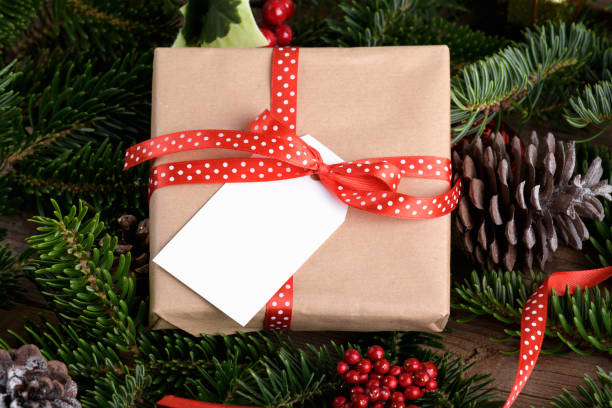 istock Christmas rectangle gift tag mockup with present box, product label mockup, with natural fir tree branch, name tag 1446099078