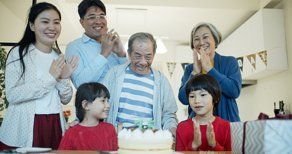 A Taiwanese family celebrating the birthday of the grandfather at home.