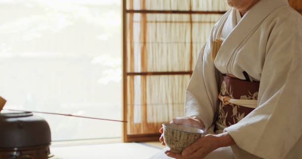 istock Tea Ceremony Host Swirling Tea in Bowl 1446100587