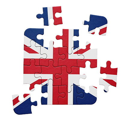 United Kingdom flag, the Union Jack, printed on jigsaw puzzle in pieces.