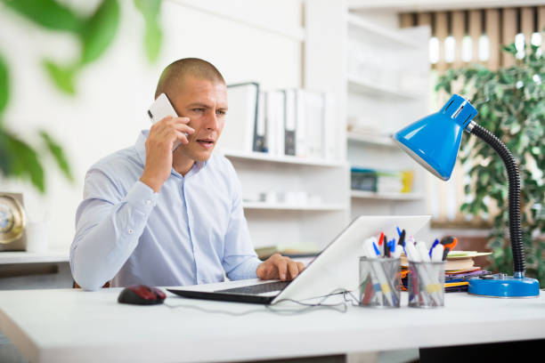 istock Office man is discussing the contract by phone in office 1446109466
