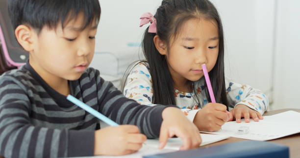 istock Japanese Schoolchildren Doing Homework 1446110459