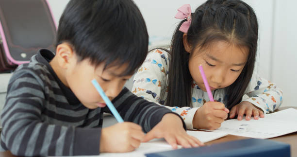 istock Japanese Schoolchildren Doing Homework 1446110460