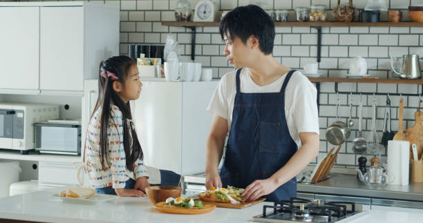 istock Dad and Daughter Chatting in Kitchen 1446110481