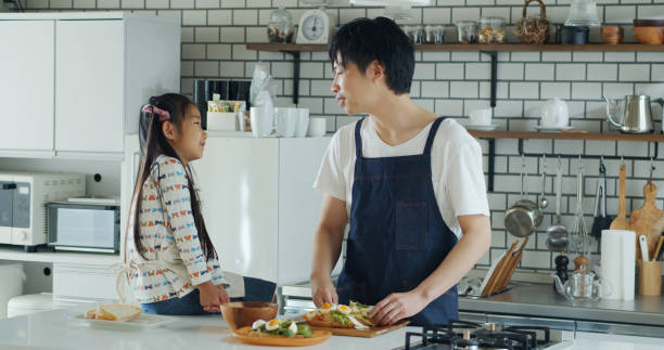istock Dad and Daughter Chatting in Kitchen 1446110482