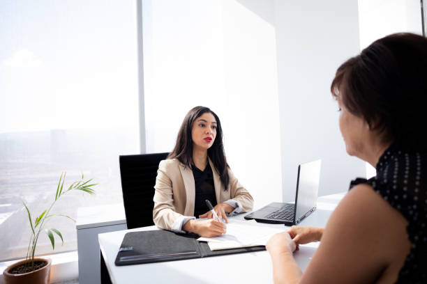 istock executive attending to clients in the office 1446111131