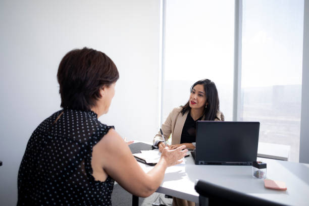 istock executive attending to clients in the office 1446111135