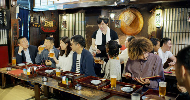 istock Waiter and Customers in Izakaya 1446112603
