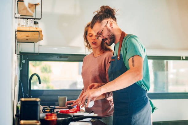 istock Young couple making breakfast together in the kitchen at home 1446112723