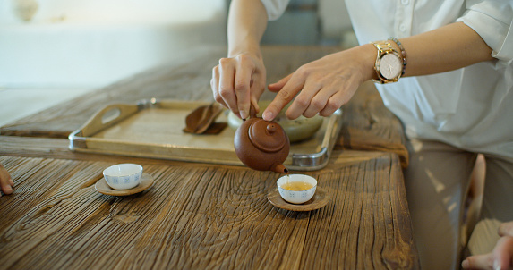 Three middle aged Asian women are enjoying an afternoon together at a tea room in Taipei, Taiwan.