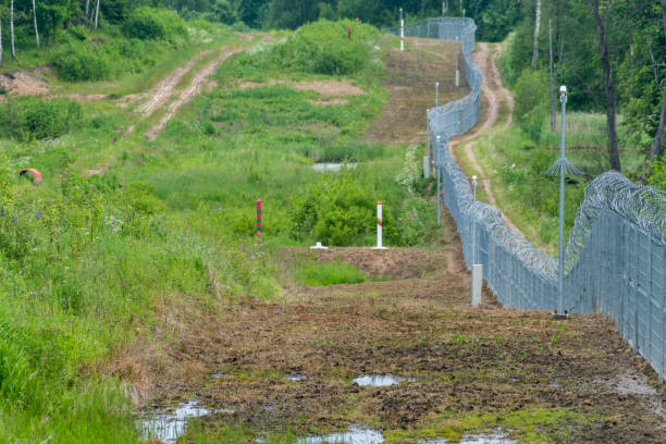 istock Lithuanian border fance on Lithuania - Russian border. 1446114577
