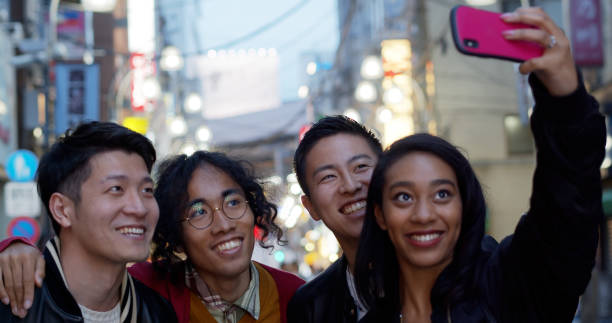 istock Woman Taking Group Selfie With Friends 1446114586