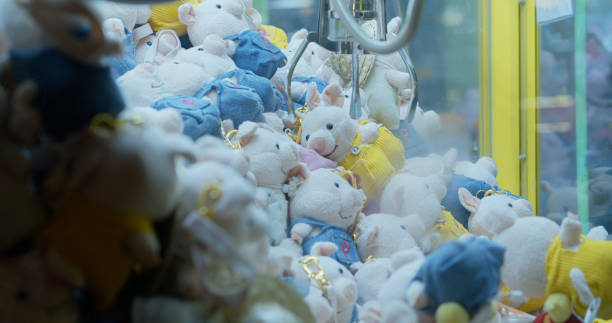 istock Stuffed Toy Pigs in Mechanical Claw Game 1446114844