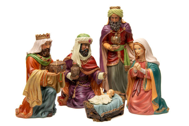 istock Adoration: Three wise men, and baby Jesus figurines on white background 1446114877