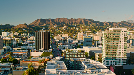 Aerial shot of Hollywood in Los Angeles, California on a sunny autumn afternoon, looking across the cityscape towards Mount Lee and Griffith Park.